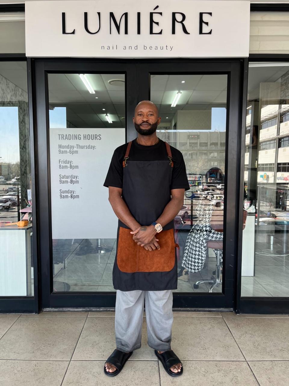 Paul standing outside Lumière in his barber’s apron